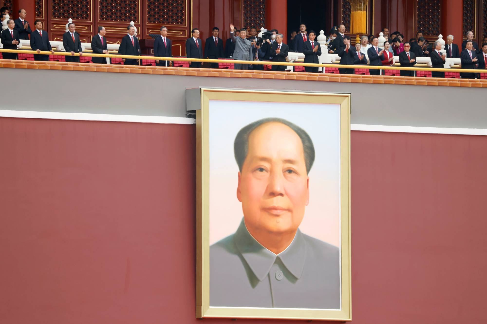 Chinese President Xi Jinping waves above a giant portrait of late Chinese chairman Mao Zedong at the end of the event marking the 100th founding anniversary of the Communist Party of China, on Tiananmen Square in Beijing in July 2021 | REUTERS