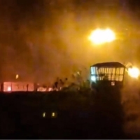 Flames and thick smoke rising from the Evin prison in Tehran on Saturday. Cities across Iran have seen protests since 22-year-old Iranian woman Mahsa Amini died on Sept. 16, after her arrest by the morality police.  | UGC / VIA AFP-JIJI