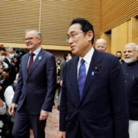 Prime Minister Fumio Kishida and Australian leader Anthony Albanese are followed by leaders of fellow \"Quad\" nations U.S. President Joe Biden and Indian Prime Minister Narendra Modi in Tokyo in May. | REUTERS