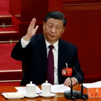 Chinese leader Xi Jinping votes during the closing ceremony of a twice-a-decade Communist Party congress at Beijing\'s Great Hall of the People on Saturday. | REUTERS