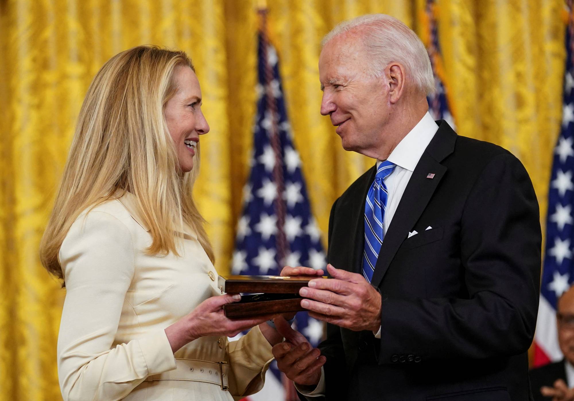 U.S. President Joe Biden greets Laurene Powell Jobs, widow of Medal of Freedom recipient Steve Jobs, in Washington in July. | Reuters U.S. President Biden awards Presidential Medals of Freedom during White House ceremony in Washington