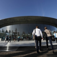 Guests arrive at the Steve Jobs Theater for an Apple in Cupertino, California, in 2019.  | REUTERS