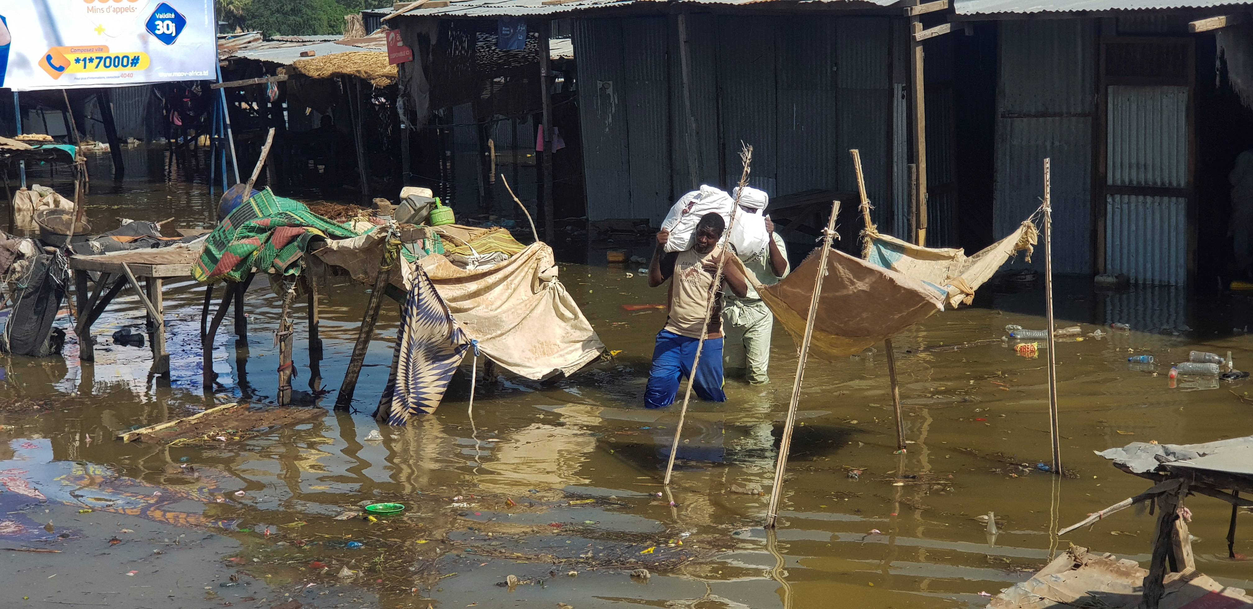 Displaced Chad citizens flee their homes on Oct. 14 following a massive flood in N'djamena.  | REUTERS