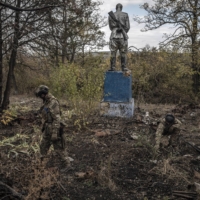 A team of Ukrainian sappers searches for unexploded ordnance on the heavily shelled grounds of a schoolyard in an area of the Kherson region of Ukraine that was previously occupied by Russian troops, on Monday | FINBARR O\'REILLY / THE NEW YORK TIMES