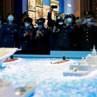 PLA members visit an exhibition at the Military Museum in Beijing on Oct. 8. | REUTERS