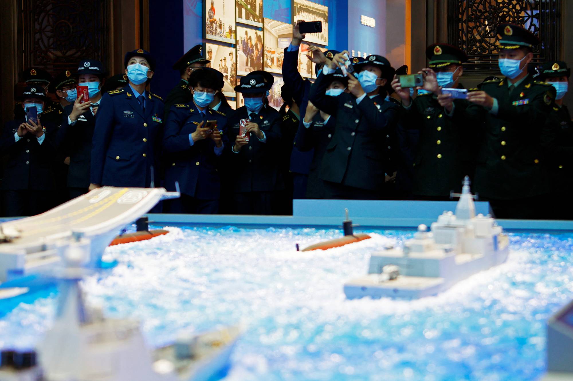 PLA members visit an exhibition at the Military Museum in Beijing on Oct. 8. | REUTERS