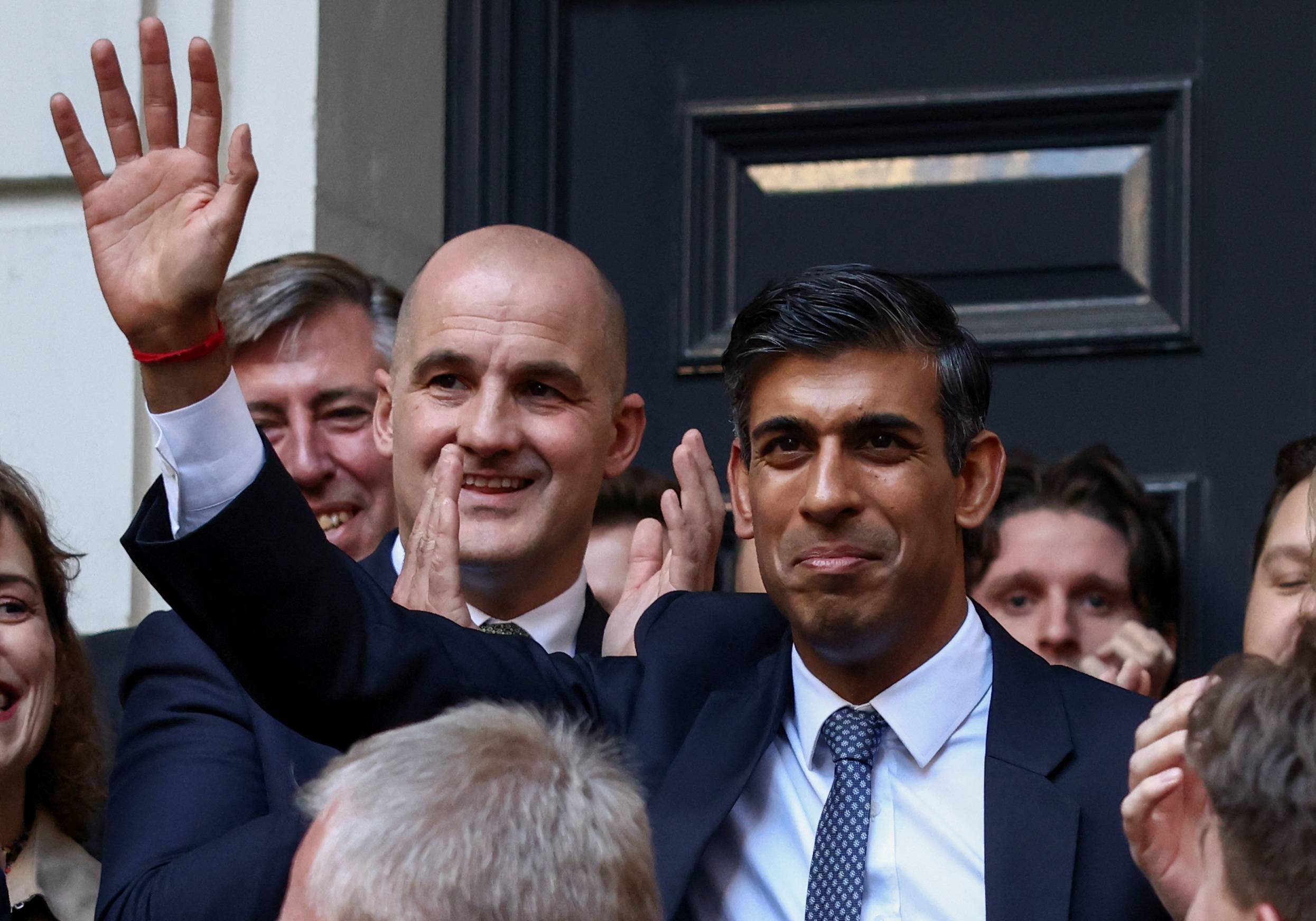 The new leader of Britain’s Conservative Party, Rishi Sunak, is greeted outside the Tories’ campaign headquarters in London on Monday. | REUTERS