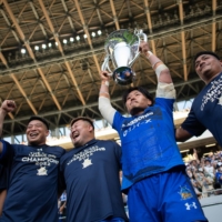 Keita Inagaki (second from right) holds up the trophy after his Panasonic Wild Knights Saitama became the inaugural Japan Rugby League One champions at Tokyo\'s National Stadium on May 29. | JOHN GUNNING