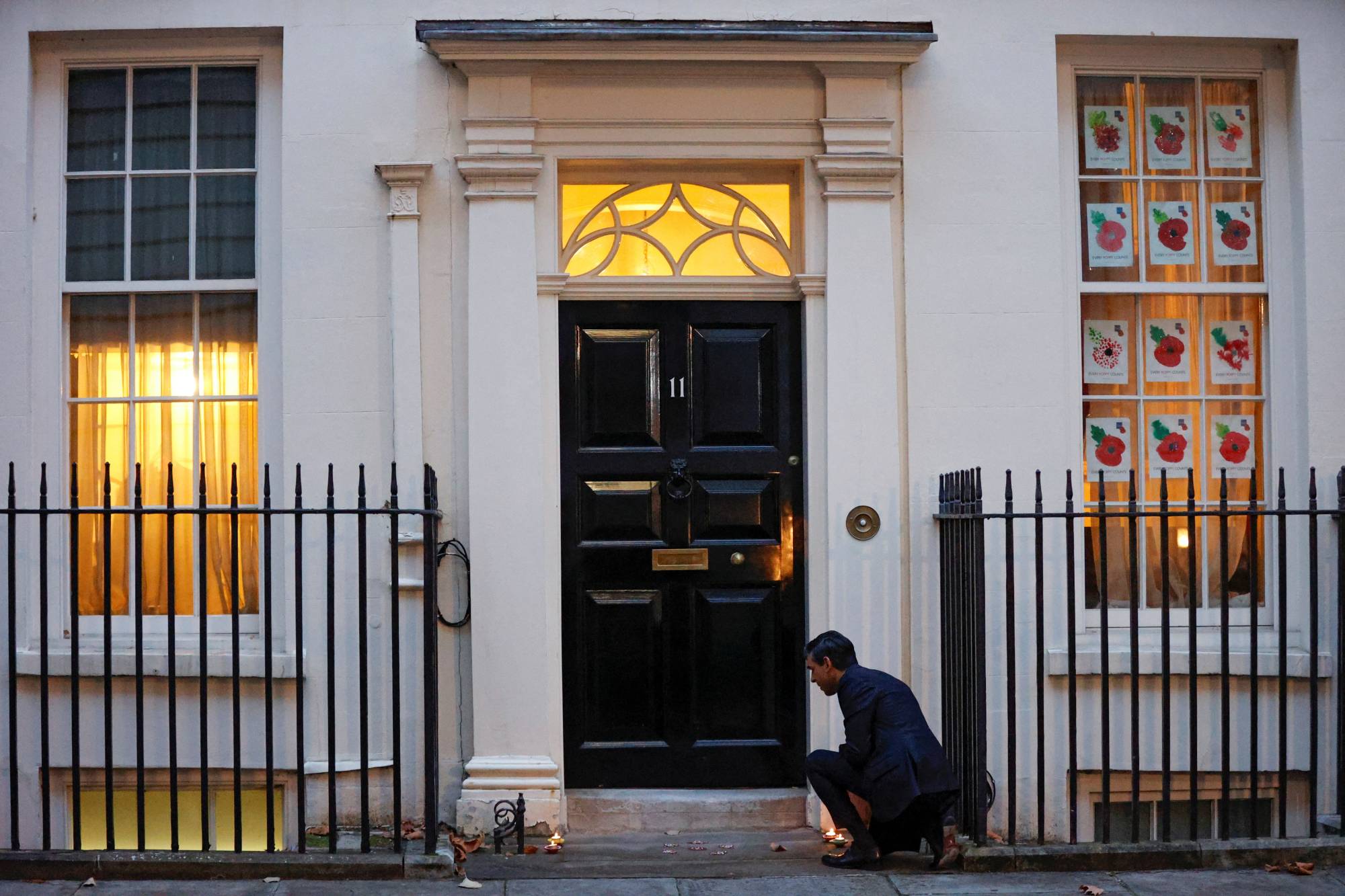 Then-British Chancellor of the Exchequer Rishi Sunak lights candles outside Downing Street ahead of the Hindu festival of Diwali, in London on Nov. 12, 2020. | REUTERS