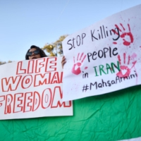 Demonstrator in Barcelona on Oct. 4 protest the death of Mahsa Amini, a Kurdish-Iranian woman who died in custody after being arrested the previous month by Iran\'s notorious morality police.
 | AFP-JIJI