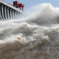 The Three Gorges dam on the Yangtze river discharges water to lower the water level in the reservoir, in Yichang, Hubei province, China, in July 2018. | REUTERS