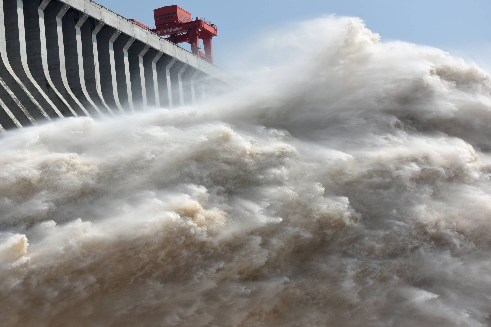 The Three Gorges dam on the Yangtze river discharges water to lower the water level in the reservoir, in Yichang, Hubei province, China, in July 2018. | REUTERS