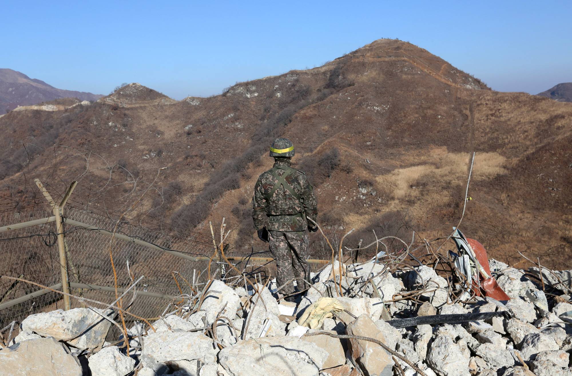 A South Korean army soldier stands guard at the South's dismantled guard post inside the Demilitarized Zone in the central section of the inter-Korean border in Cheorwon, in December 2018. | REUTERS