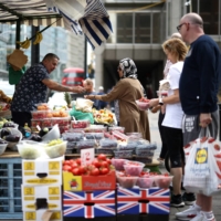 A fruit and vegetable market stall in central London. Rampant inflation is pushing many British households toward cheaper processed meals. | REUTERS