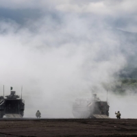 Ground Self-Defense Force amphibious assault vehicles take part in a live-fire exercise in Gotemba, Shizuoka Prefecture, in May.  | POOL / VIA REUTERS