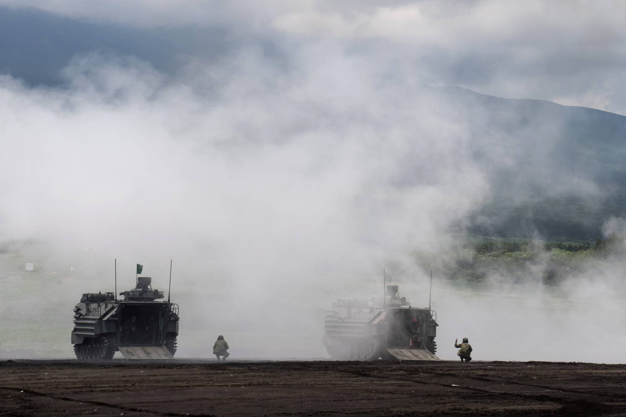 Ground Self-Defense Force amphibious assault vehicles take part in a live-fire exercise in Gotemba, Shizuoka Prefecture, in May.  | POOL / VIA REUTERS