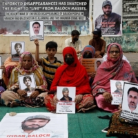 Family members of missing or disappeared persons hold portraits of their loved ones during a protest in Karachi in July. | REUTERS
