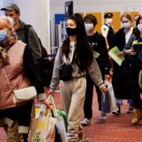 Ukrainian refugees arrive at Haneda Airport in Tokyo in April. | REUTERS