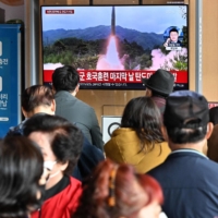 A TV screen showing file footage of a North Korean missile test in Seoul on Friday | AFP-JIJI