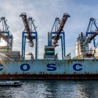 The Chinese container ship COSCO Pride is unloaded at the Tollerort Container Terminal in the harbor city of Hamburg, Germany, on Oct. 26. | AFP-JIJI