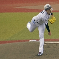 Marines pitcher Roki Sasaki pitches during batting practice in Chiba on Tuesday. | KYODO