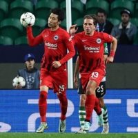 Daichi Kamada (left) celebrates after scoring Frankfurt\'s first goal against Sporting in Lisbon on Tuesday. | REUTERS