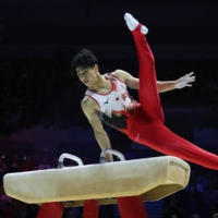 Daiki Hashimoto performs on the pommel horse during the men\'s final at the gymnastics world championships in Liverpool, England, on Wednesday. | REUTERS