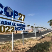 A COP27 sign on the road leading to the conference area in Egypt\'s resort city of Sharm el-Sheikh on Oct. 20. Climate activism — like any activism in Egypt — can be a perilous undertaking. | REUTERS