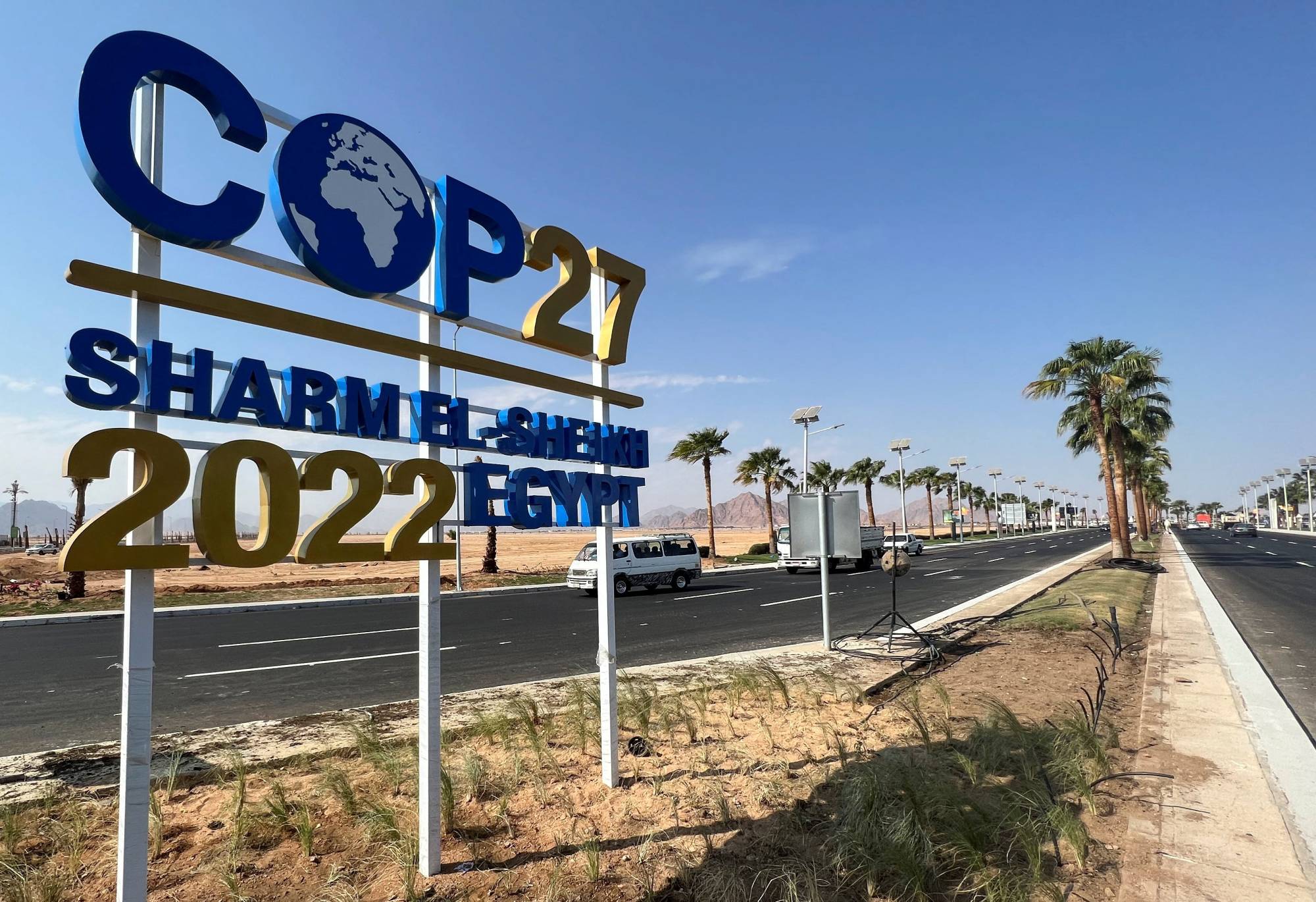 A COP27 sign on the road leading to the conference area in Egypt's resort city of Sharm el-Sheikh on Oct. 20. Climate activism — like any activism in Egypt — can be a perilous undertaking. | REUTERS