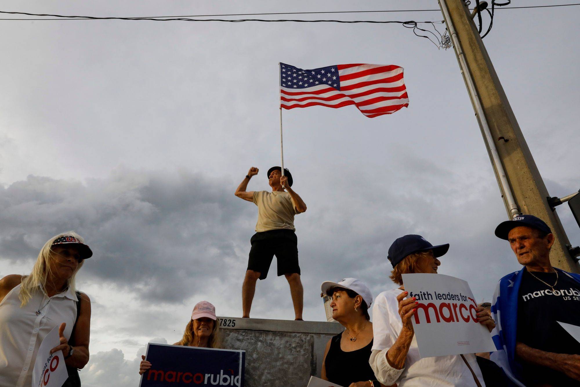 Supporters of Sen. Marco Rubio, a Republican from Florida, hold signs ahead of an election debate in Lake Worth, Florida, on Oct. 18. | Bloomberg 