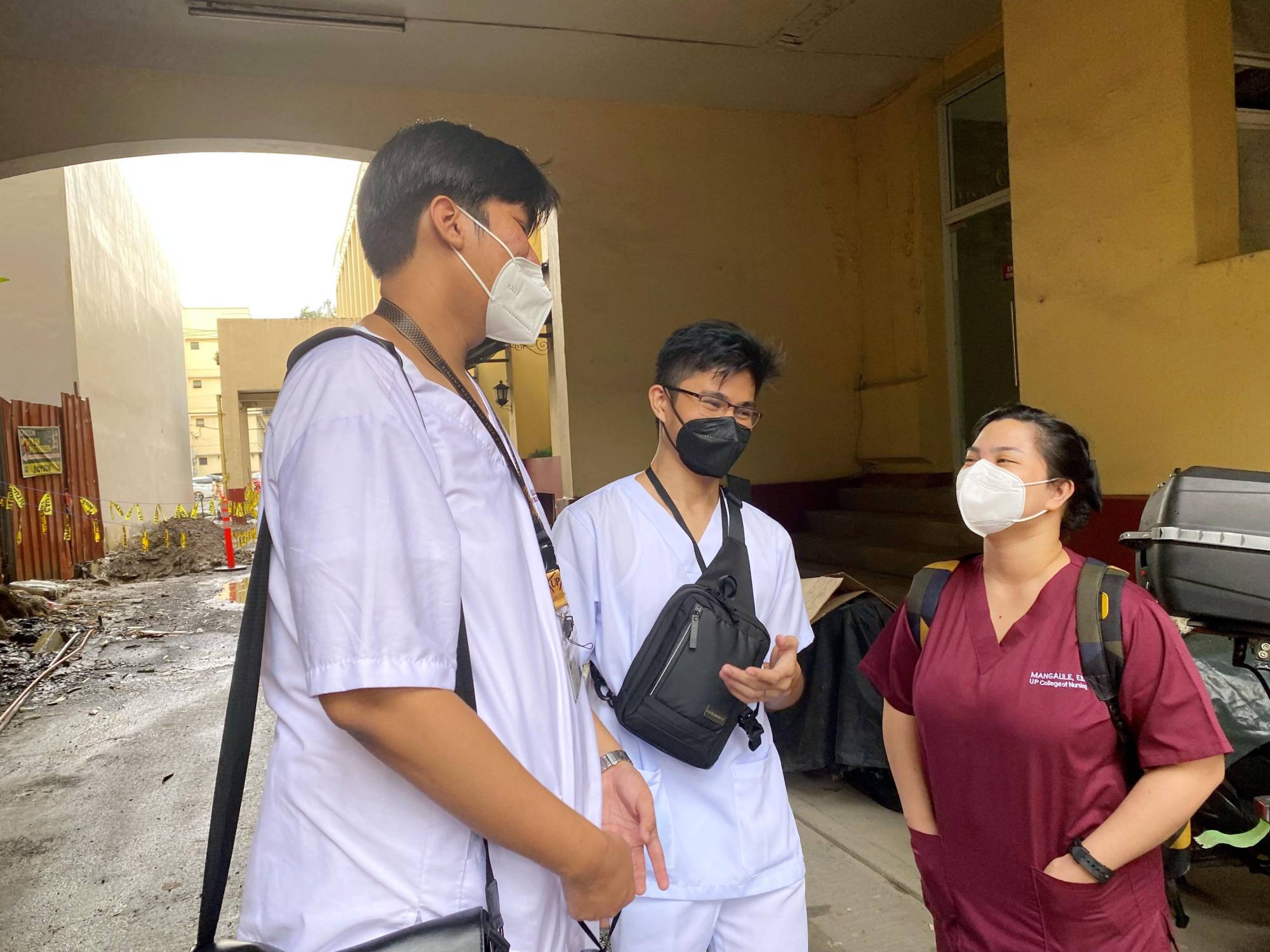 Junior nursing student Jan Yago (center) talks with fellow students in Manila on Oct. 29. Yago hopes to obtain employment in Japan after gaining sufficient work experience in the Philippines. | KYODO