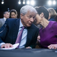 Jamie Dimon (left), chairman and chief executive officer of JPMorgan Chase & Co., speaks with Jane Fraser, chief executive officer of Citigroup Global Markets Inc., following a Senate Banking, Housing and Urban Affairs Committee hearing in Washington on Sept. 22. | BLOOMBERG