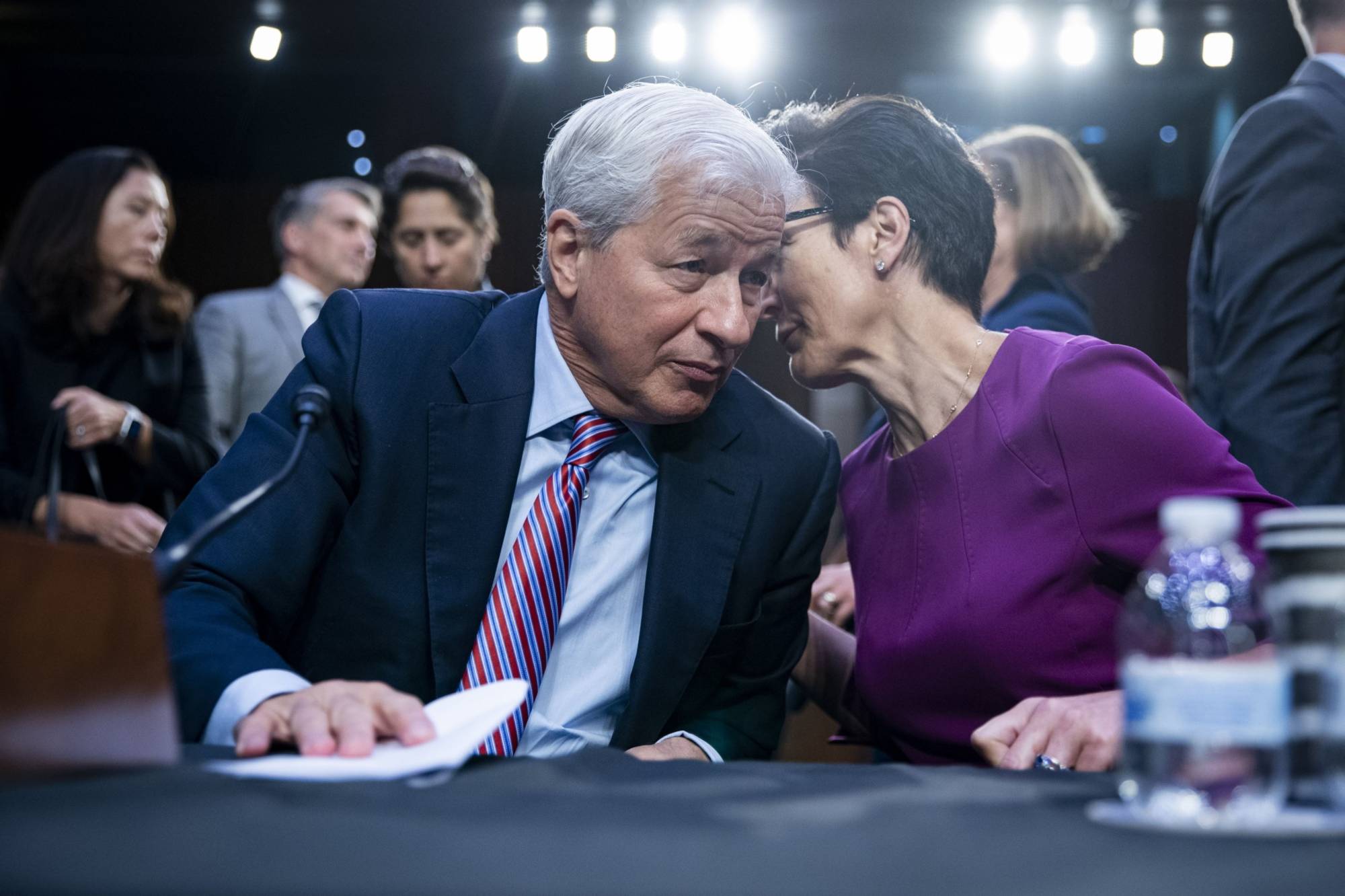 Jamie Dimon (left), chairman and chief executive officer of JPMorgan Chase & Co., speaks with Jane Fraser, chief executive officer of Citigroup Global Markets Inc., following a Senate Banking, Housing and Urban Affairs Committee hearing in Washington on Sept. 22. | Bloomberg
