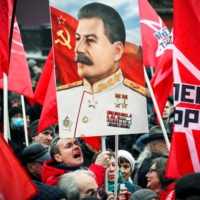 Russian Communist party supporters shout holding a portrait of late Soviet leader Joseph Stalin while attending a rally in central Moscow on Monday, marking the 105th anniversary of the October 1917 Bolshevik Revolution. | AFP-JIJI
