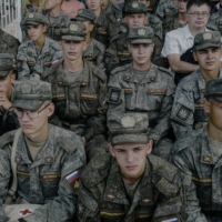 Russian conscripts watch a tank demonstration in Moscow, in August.  | NANNA HEITMANN / THE NEW YORK TIMES