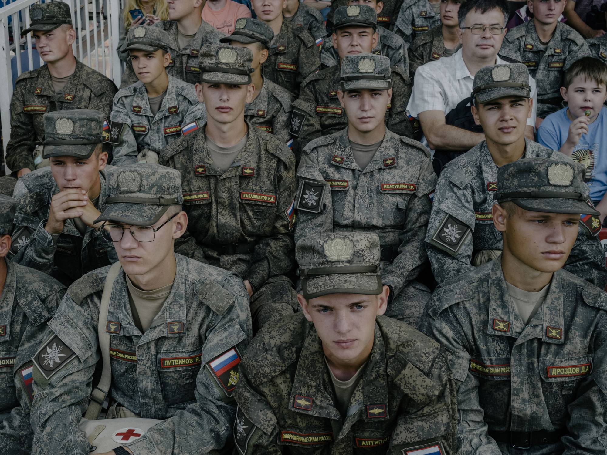 Russian conscripts watch a tank demonstration in Moscow, in August.  | Nanna Heitmann / The New York Times
