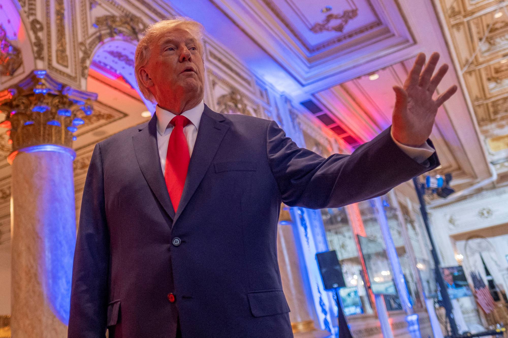 Former U.S. President Donald Trump talks to members of the media on the grounds of his Mar-a-Lago resort on Tuesday night in Palm Beach, Florida. | REUTERS