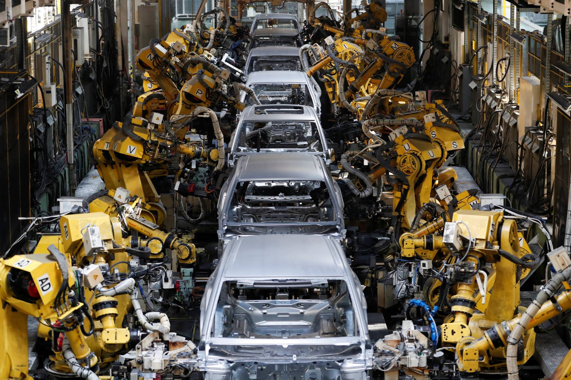 Robots weld bodyshells of cars on the assembly line in a Suzuki plant in Hungary in October. The automaker is still unable to meet demand due to a chip shortage. | REUTERS