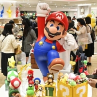 Visitors browse items at Nintendo Osaka on Thursday, ahead of its full opening on Friday. | KYODO