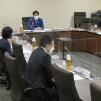 Government officials discuss incidents of children left in vehicles during a meeting in Tokyo in October. | KYODO