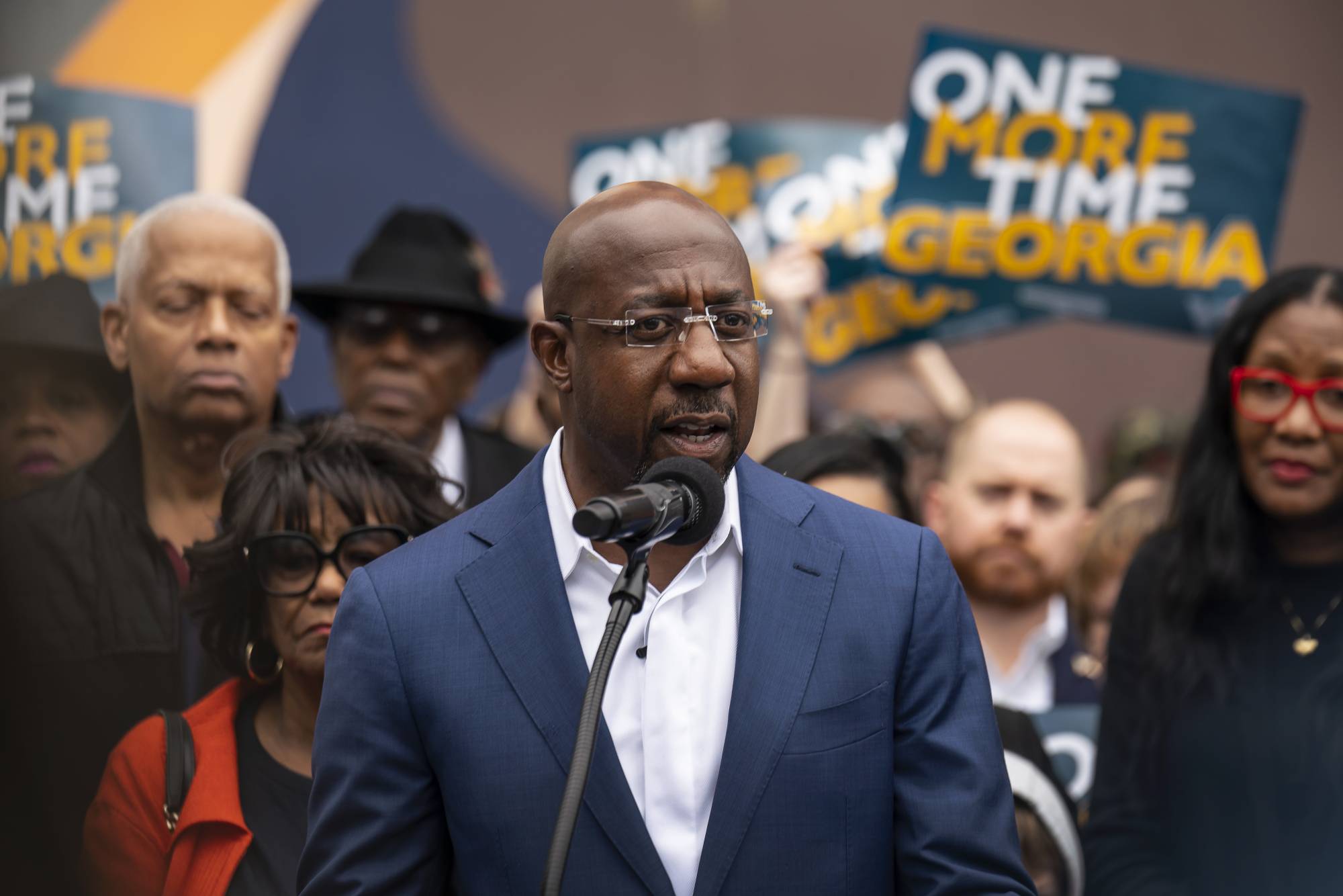 Democratic Sen. Raphael Warnock speaks by a mural of John Lewis in Atlanta on Thursday as Georgia's Senate election headed to a runoff contest. | Nicole Craine / The New York Times