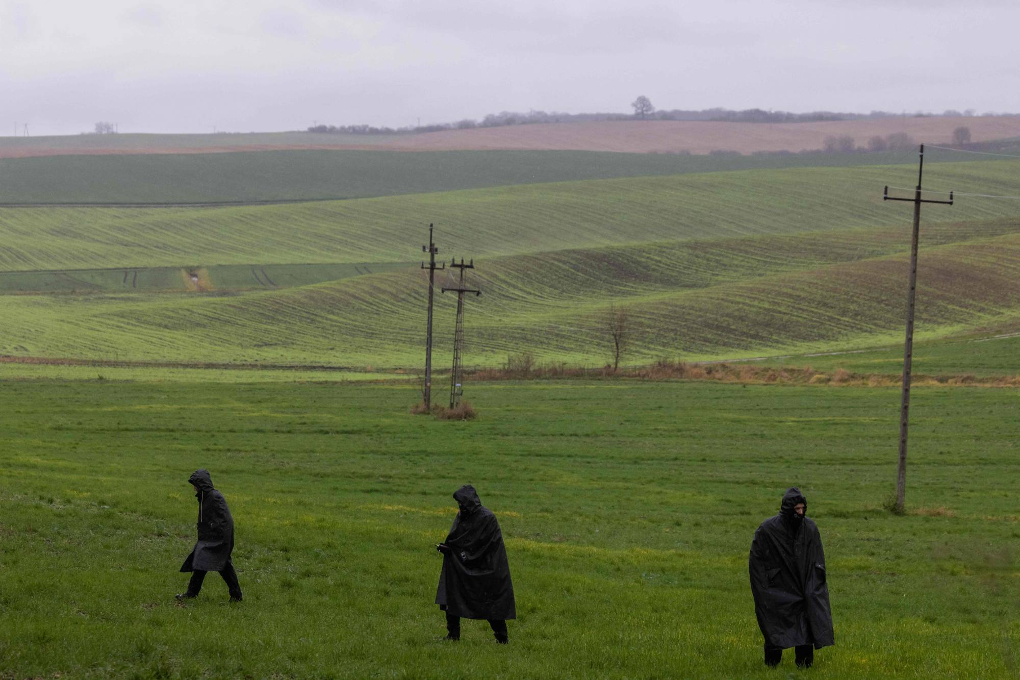 Police investigators on Wednesday in the fields near the site where a missile strike killed two men in Przewodow | AFP-Jiji