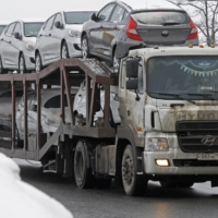 New Hyundai vehicles are transported on a highway leading from Moscow in February 2013. The firm boasted a 10% share of car sales in Russia in 2021. | REUTERS