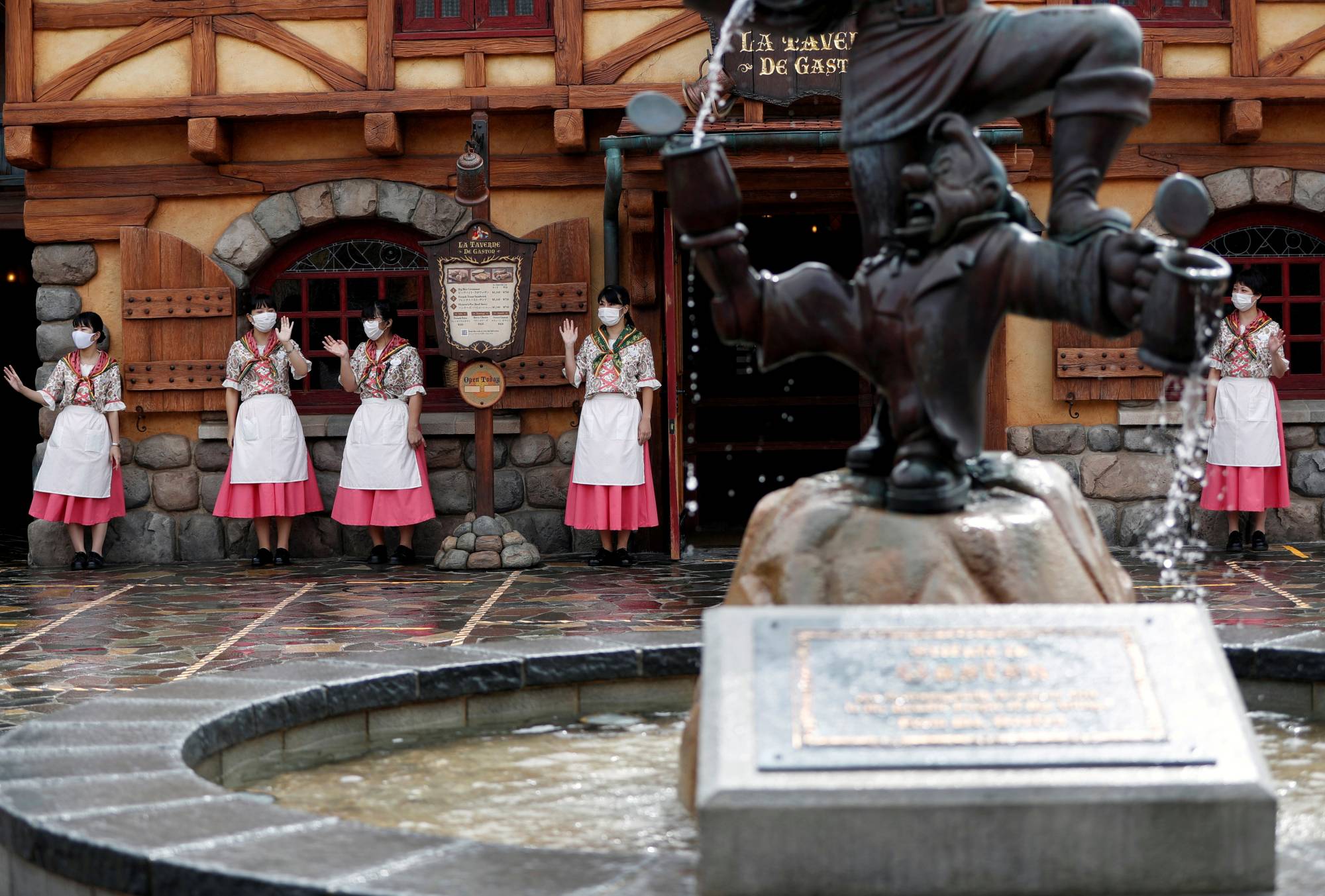 Staff members at Tokyo Disneyland in Urayasu, Chiba Prefecture, in September 2020.  | REUTERS 
