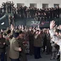 North Korean leader Kim Jong Un celebrates on the day of the launch of an intercontinental ballistic missile in this undated photo released Saturday. | KCNA / VIA REUTERS