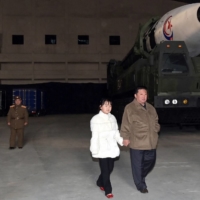 North Korean leader Kim Jong Un inspects an intercontinental ballistic missile with his daughter in this undated photo released on Saturday. | KCNA / VIA REUTERS