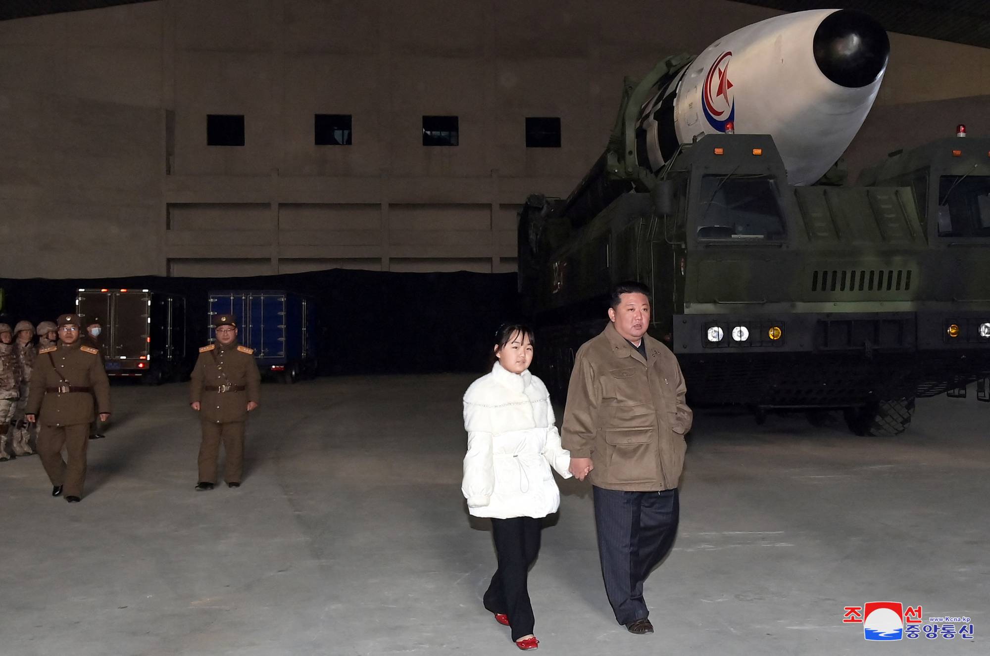 North Korean leader Kim Jong Un inspects an intercontinental ballistic missile with his daughter in this undated photo released on Saturday. | KCNA / via REUTERS
