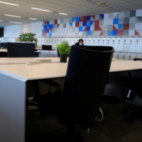 An employee wearing a mask works in an office where the majority of staff work remotely at the headquarters of Fujitsu in Tokyo in August 2020.  | REUTERS