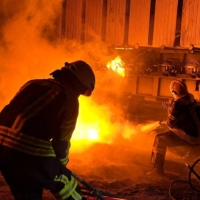 Firefighters work to put out a fire at energy infrastructure facilities, damaged in a Russian missile strike, as Moscow\'s attack on Ukraine continues, in the Kyiv region, on Tuesday.  | STATE EMERGENCY SERVICE OF UKRAINE / VIA REUTERS    
