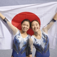 Megu Uyama (left) and Hikaru Mori celebrate after winning the women\'s synchro final at the trampoline gymnastics world championships in Sofia on Saturday. | KYODO